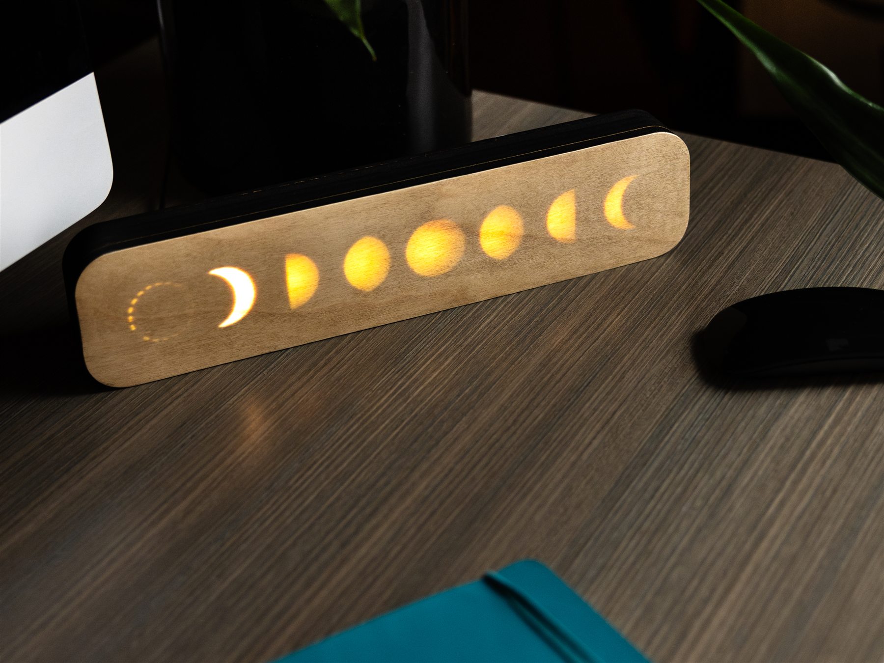 LunaKron moon phase display glowing on a dark desk